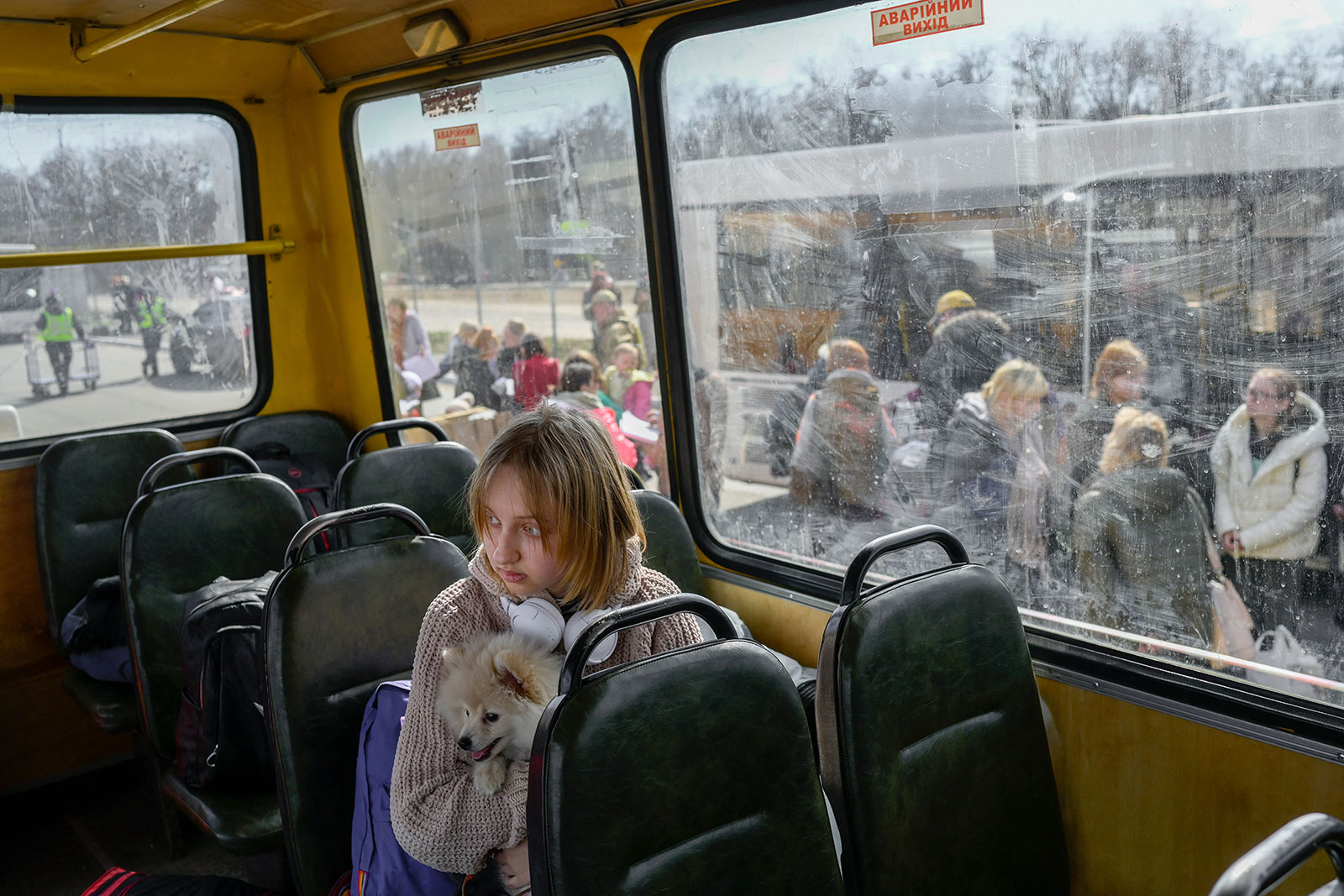A young girl with her dog arrives at a center for internally displaced people in Zaporizhzhia on Wednesday.