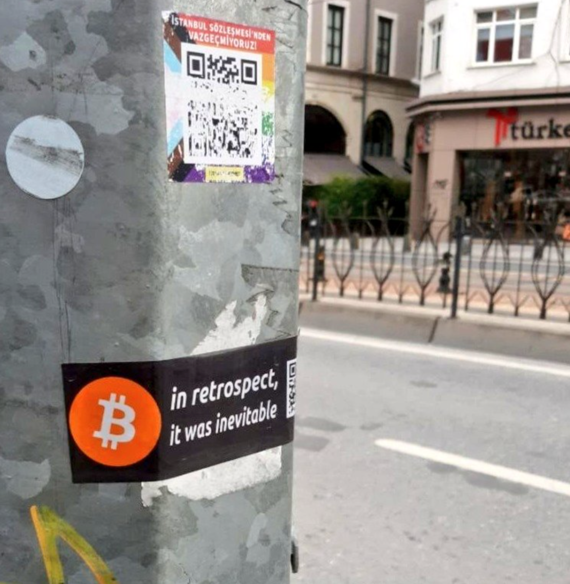 ₿ street art sticker on pole