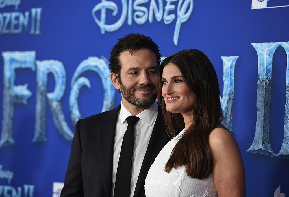 Idina Menzel, Aaron Lohr. Idina Menzel, right, and Aaron Lohr arrive at the world premiere of 