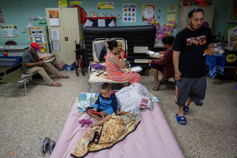 Evacuees are seen in a classroom of a public school being used as a shelter as Hurricane Fiona and its heavy rains approach in Guayanilla, Puerto Rico, on Sunday.