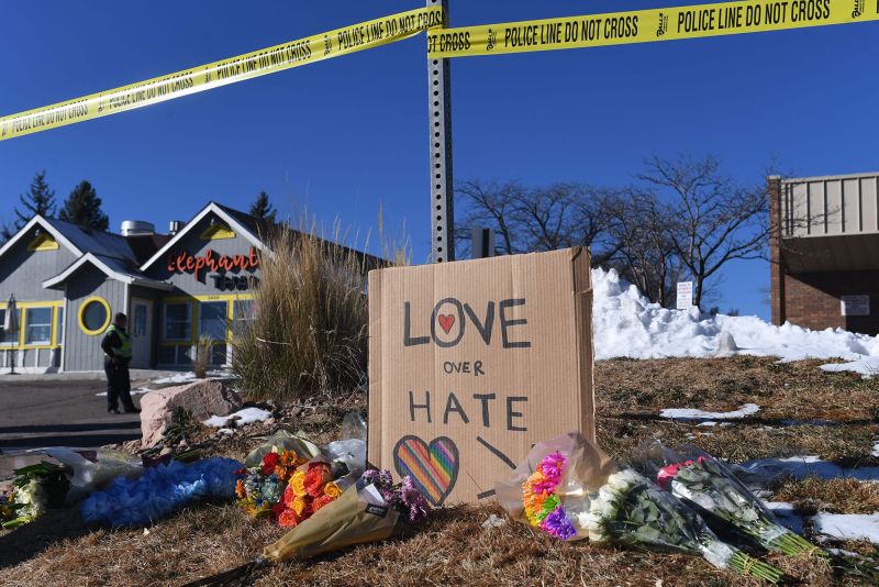 Bouquets of flowers and a sign reading "Love Over Hate" were left near Club Q on Sunday, November 20, 2022.