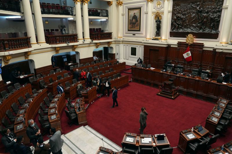 Lawmakers stand inside Congress on the day of their planned impeachment vote on President Pedro Castillo in Lima, Peru, Wednesday, Dec. 7, 2022.